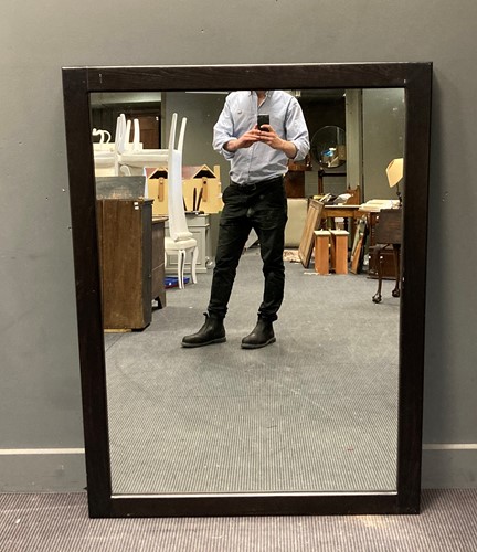 Lot 576 - A large modern wall mirror with black frame,...