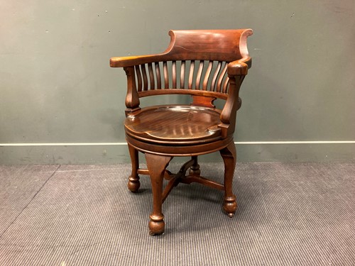 Lot 570 - An early 20th century mahogany swivel desk...