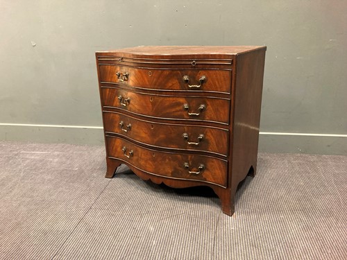 Lot 571 - A caddy top serpentine front mahogany chest of...