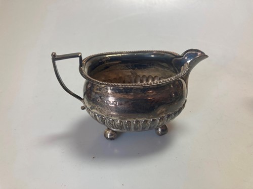 Lot 248 - A silver teapot and milk jug, together with a...