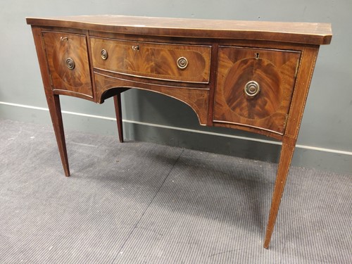 Lot 566 - A 19th century mahogany serpentine sideboard,...