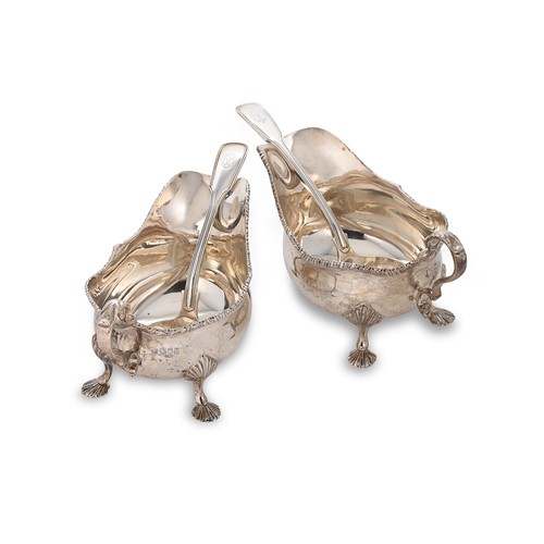 Lot 446 - A pair of George V silver sauce boats together with a pair of earlier silver ladles