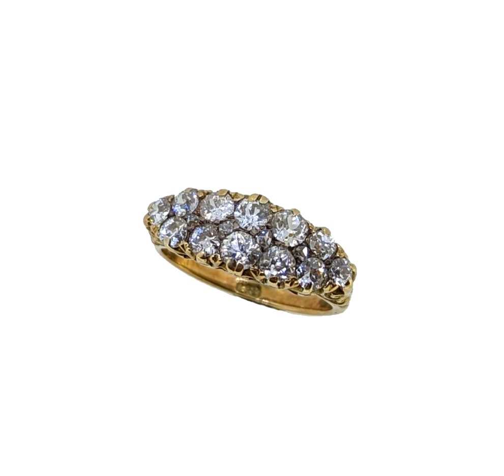 Lot 140 - A carved half hoop style diamond cluster