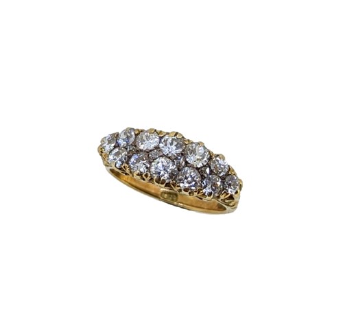 Lot 140 - A carved half hoop style diamond cluster ring