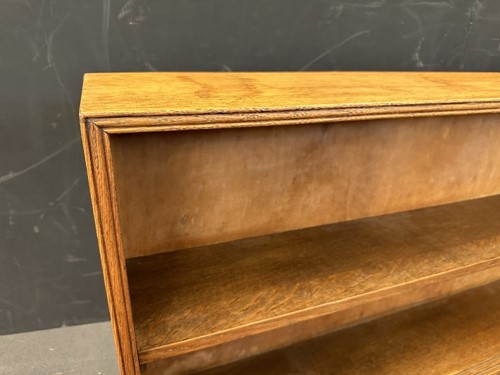Lot 184 - A Cotswold School oak low bookcase
