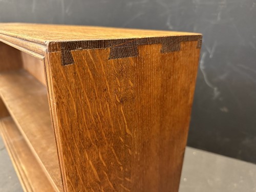 Lot 184 - A Cotswold School oak low bookcase