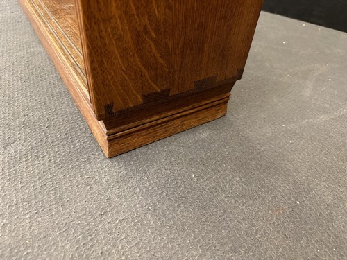 Lot 184 - A Cotswold School oak low bookcase