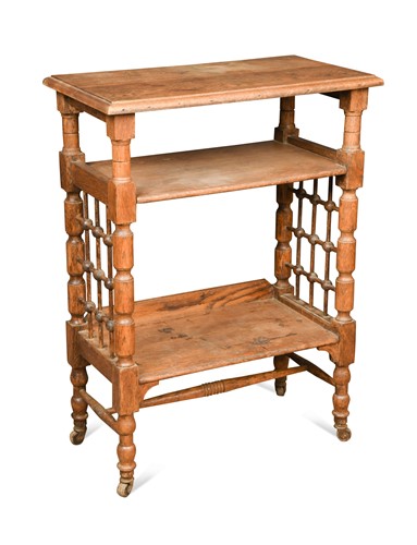 Lot 176 - Leonard Wyburd for Liberty & Co., an oak three tier book or side table, circa 1900