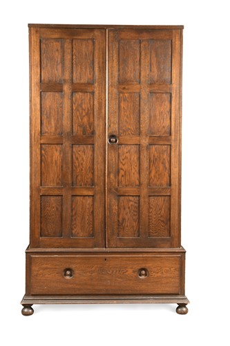 Lot 172 - An Arts & Crafts oak wardrobe in the manner of Heal's, circa 1920