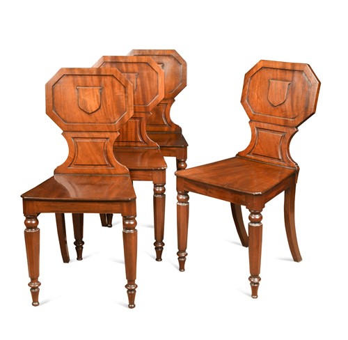 Lot 660 - A set of four William IV mahogany hall chairs