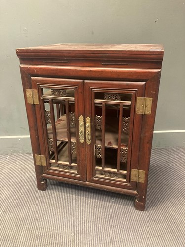Lot 457 - A Chinese hardwood two-door cabinet with open...