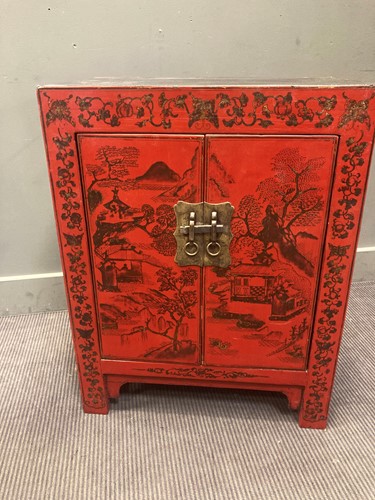 Lot 456 - A red and black lacquer cabinet painted with a...