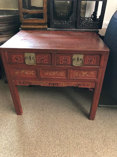 Lot 465 - A Chinese red lacquered table with two frieze...