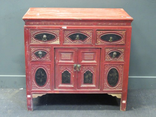 Lot 461 - A Chinese red and black painted cabinet with...