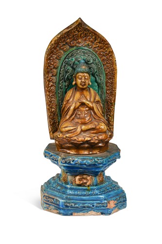 Lot 69 - A Sancai glazed pottery Buddha on a pedestal, Ming Dynasty