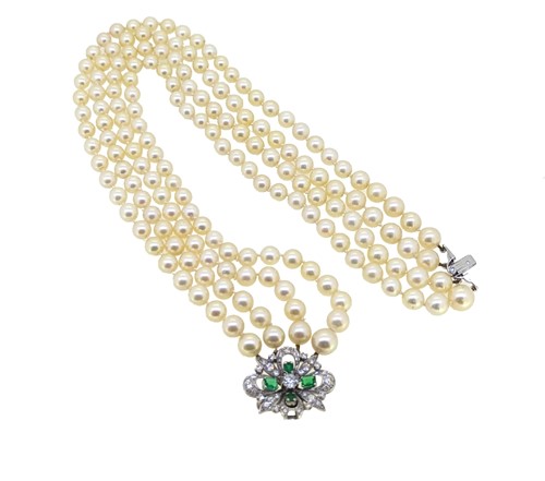 Lot 69 - A four row pearl choker with a diamond and emerald clasp