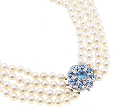 Lot 124 - A four row pearl necklace with a stone set decorative clasp