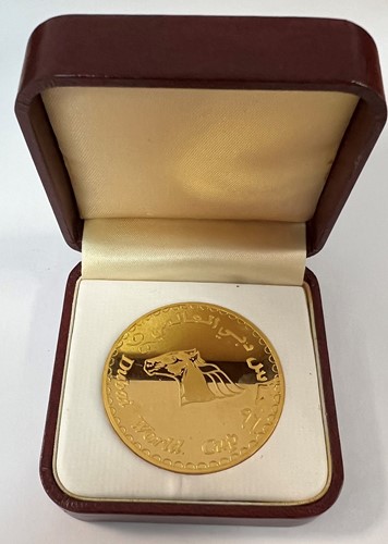 Lot 284 - A Dubai metalwares coin commemorating the inaugural Dubai World Cup horse race & shopping festival