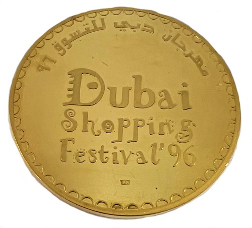 Lot 284 - A Dubai metalwares coin commemorating the inaugural Dubai World Cup horse race & shopping festival