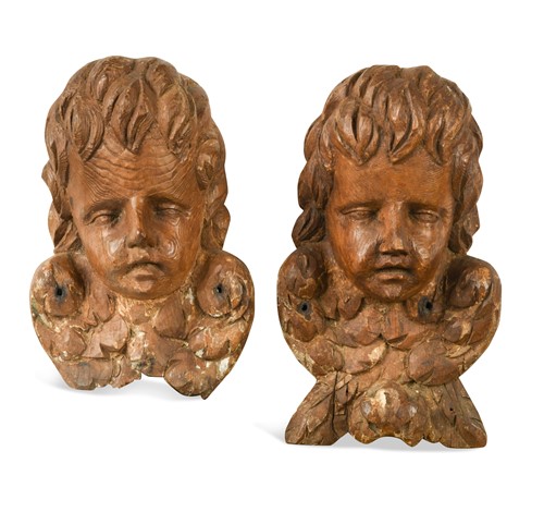 Lot 580 - A pair of 17th century style carved wood cherubs' heads