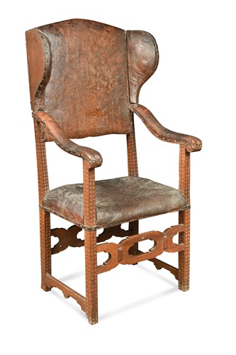 Lot 561 - A Continental leather upholstered wing back armchair, 18th century