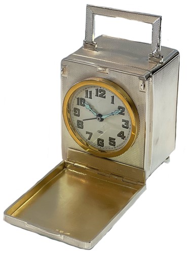 Lot 226 - Unsigned - A Sterling silver travelling clock with unusual front cover and rear compartment