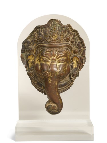 Lot 157 - A Tibetan gilt and repousse copper Ganesh head mount, 17th century