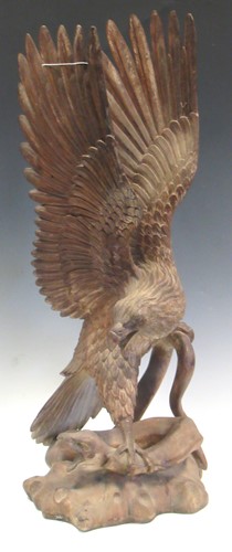 Lot 111 - A carved wooden eagle and serpent, possibly...