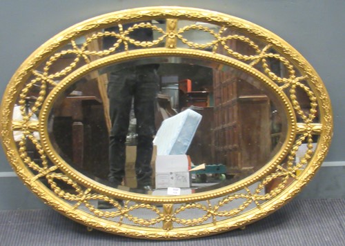 Lot 458 - A George III style sectional oval wall mirror,...