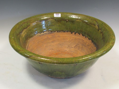 Lot 113 - A large earthenware bowl partially covered in...