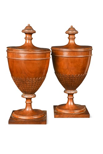 Lot 766 - A pair of George III style mahogany urns with covers