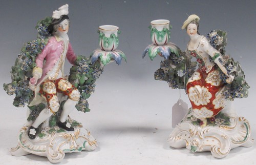 Lot 37 - A pair of Derby porcelain figural bocage back...