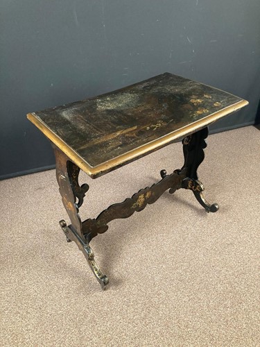Lot 753 - A black lacquered and painted papier mache...
