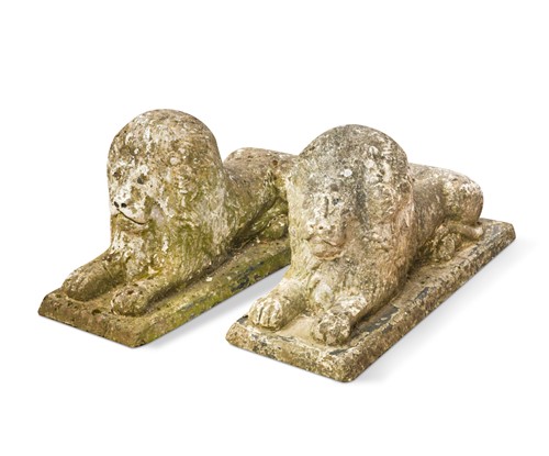 Lot 868 - A pair of composite stone garden lions, 20th century