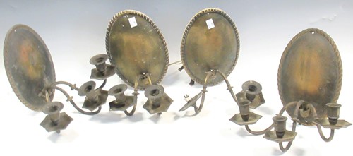 Lot 489 - A set of four brassed metal wall lights with...