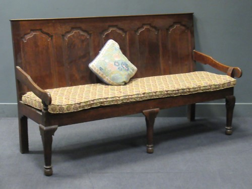 Lot 424 - A late Georgian oak five-panel backed settle,...