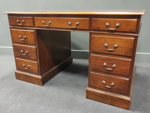 Lot 409 - A mahogany pedestal desk with an inset red...