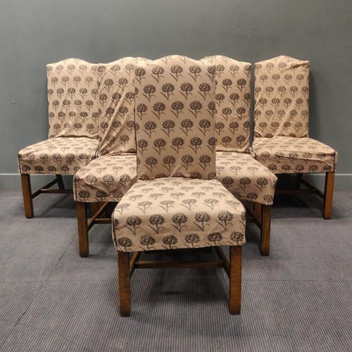 Lot 434 - A set of eight oak dining chairs united by an...