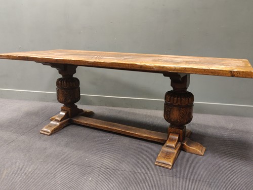Lot 433 - An oak refectory table raised on cup and cover...