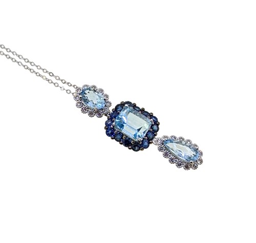 Lot 93 - A modern aquamarine and sapphire pendant and chain