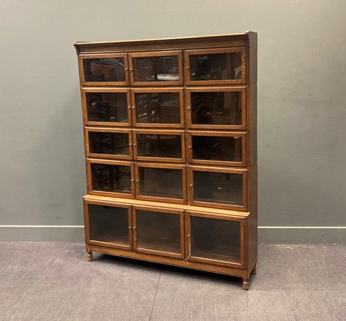 Lot 483 - A 20th century sectional oak glazed bookcase,...