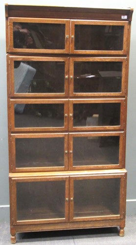 Lot 484 - A 20th century sectional oak glazed bookcase,...