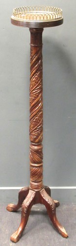 Lot 457 - A torchiere stand, carved with foliage, the...
