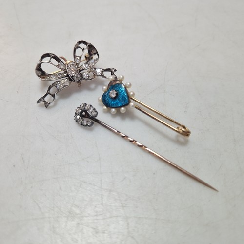 Lot 179 - A diamond set horseshoe stick pin, together...