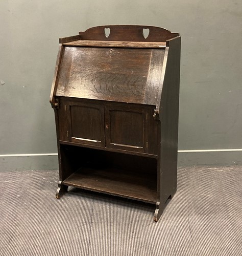Lot 511 - An early 20th century Arts & Crafts oak bureau...