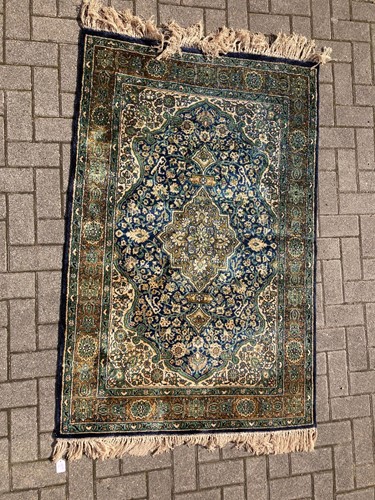 Lot 566 - A green silk rug, 177 x 108cm