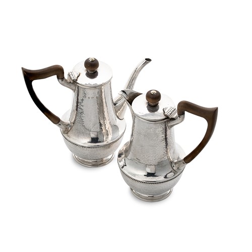 Lot 424 - A George V silver ‘Arts & Crafts’ style bachelor’s coffee pot and hot water jug, mark of A.E. Jones