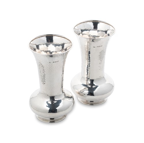 Lot 430 - A pair of George V silver ‘Arts & Crafts’ style trumpet vases, mark of A.E. Jones
