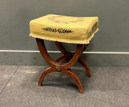 Lot 329 - A continental stool with needlework top on X...