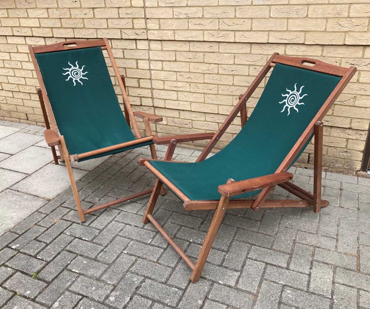 Lot 550 - A pair of hardwood steamer-style deck chairs...